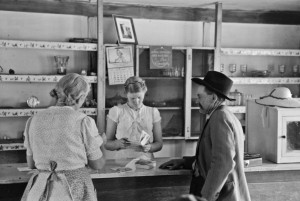 Russell Lee - Louis Stagg who runs the cafe and her mother looking at greeting cards which the salesman has. Pie Town, New Mexico, 1940