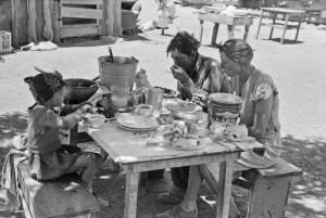 Russell Lee - The Caudill family eating dinner in the open the day thew were moving their dugout. Pie Town, New Mexico, 1940